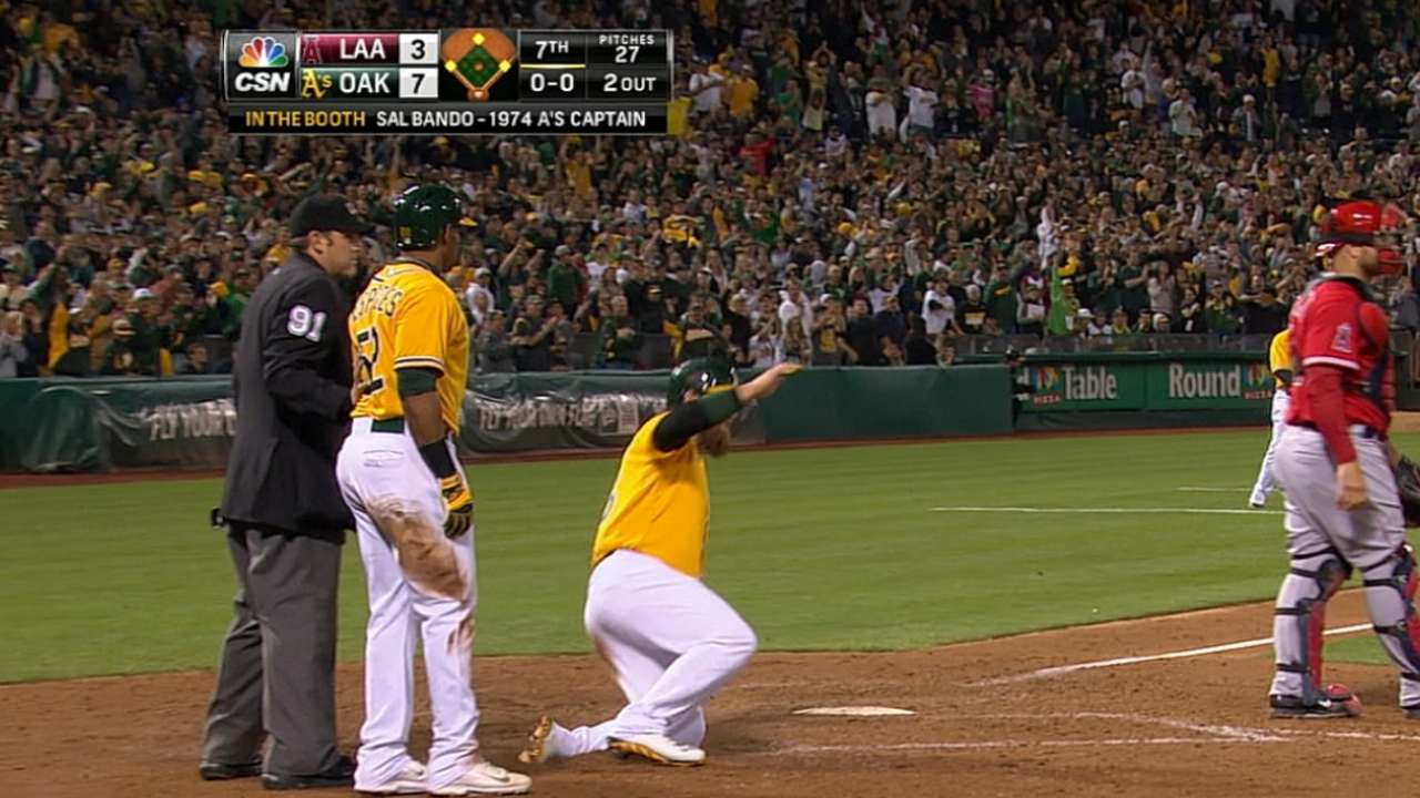 Cespedes helps A's charge past Angels