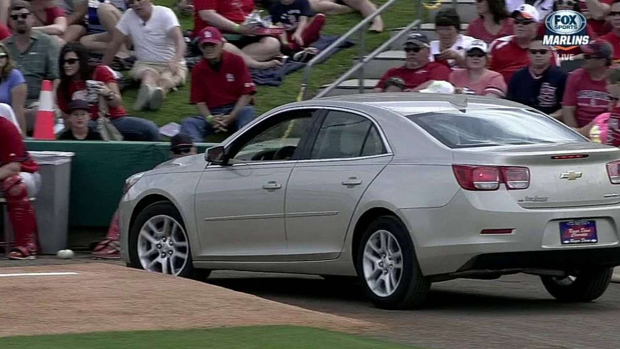 Car drives past bullpen
