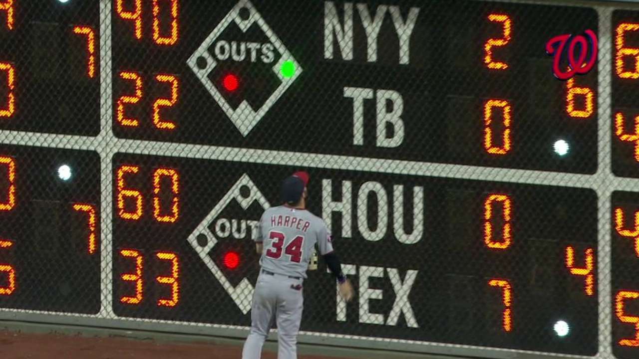 Harper signs homer ball for fan