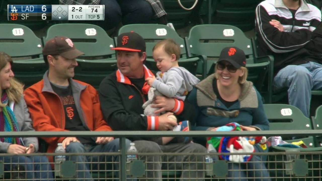 Fan catches ball holding baby
