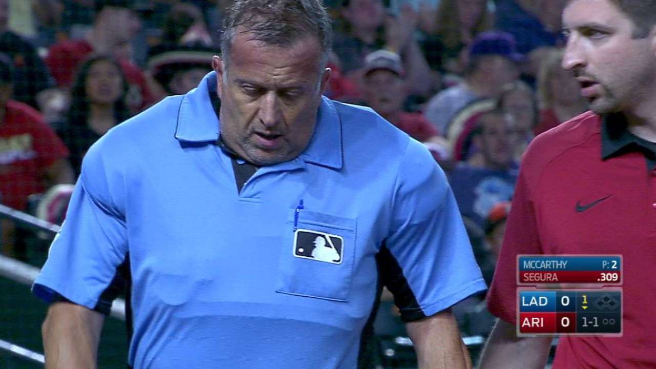 Umpire exits in 1st after foul tip hits mask