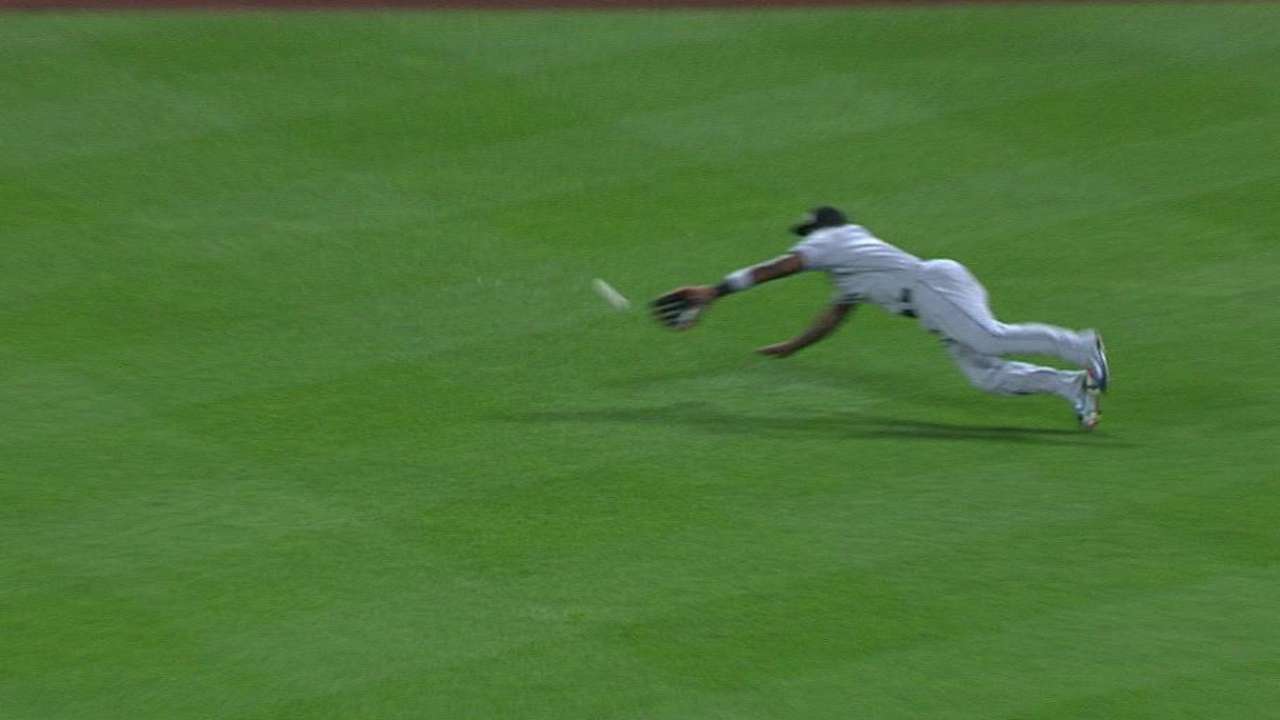 Ozuna injures left wrist making diving catch