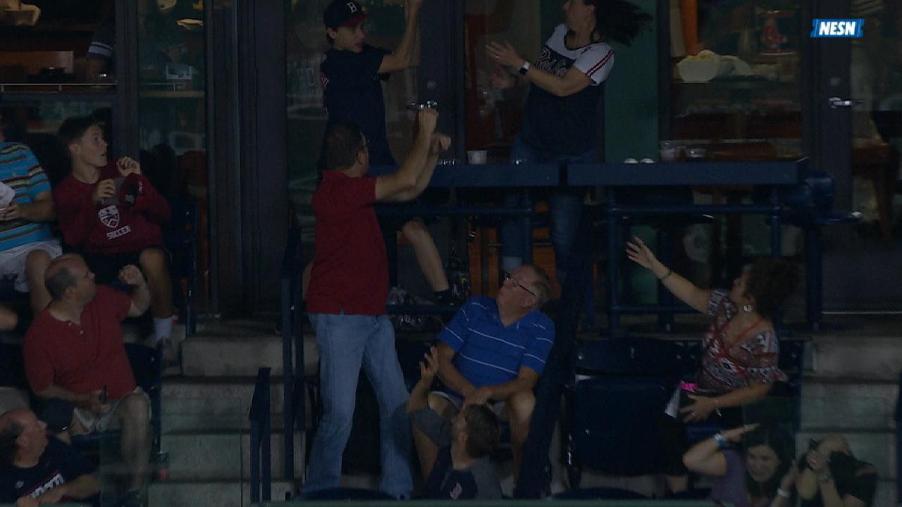Foul ball passes fan's arms, into another's hands